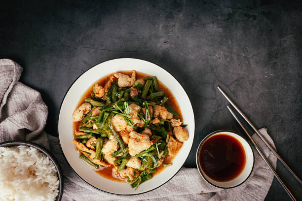 istock Top view,  Stir-fried pork and red hot curry paste with or long bean and Ingredients are oyster sauce, fish sauce, sugar, kaffir lime leaves in the dish Eat with cooked rice. Thai food 1465969685