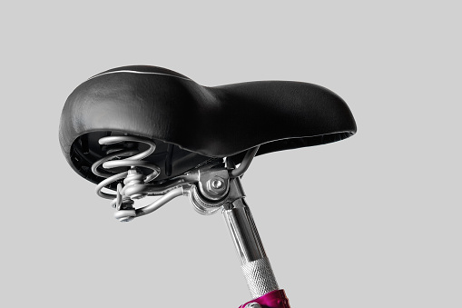 Bicycle saddle wide. Seat post. Close-up. Isolated on light gray background.