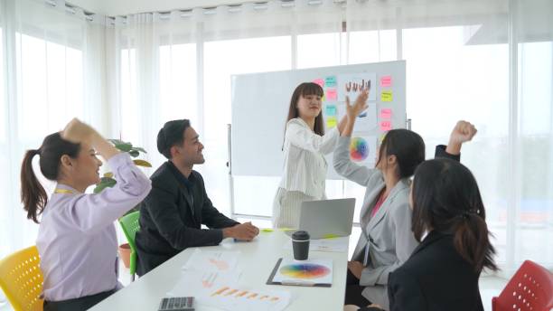 istock Business people proficiently celebrate project success at office workplace . Corporate business team collaboration concept . 1465973708