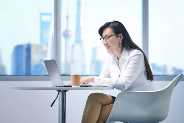 istock Asia Woman Smiling Looking Laptop 1465981644