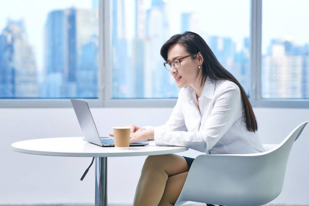 istock Asia Woman Smiling Looking Laptop 1465981675