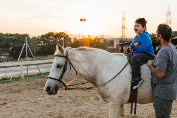 istock Child with disabilities having fun while enjoying a horseback ride. 1465981853