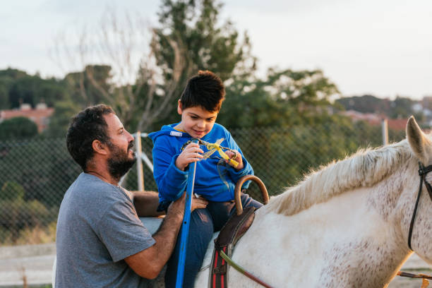 istock Child with disability doing exercises with the physiotherapist during equine therapy. 1465983606