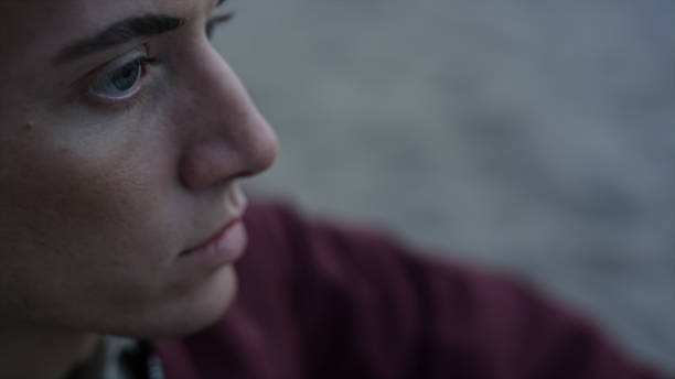 istock Closeup serious man sitting on beach. Handsome guy face with sad emotion 1465990781
