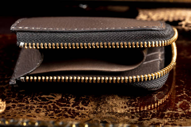 istock Leather wallet with a golden zipper close-up on a dark background. 1466003050