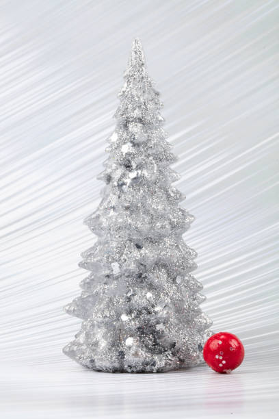 istock Christmas composition. Silver Christmas tree on a silver background. Happy Holidays. Minimal new year concept. 1466003222