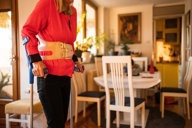 istock Woman walking with crutches 1466005620