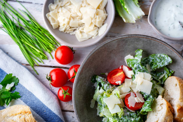 istock Green salad with tomatoes, bread and parmesan cheese 1466008814