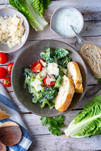 istock Green salad with tomatoes, bread and parmesan cheese 1466008868