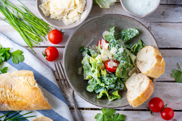 istock Green salad with tomatoes, bread and parmesan cheese 1466009091