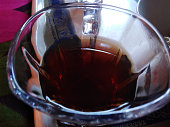 Herbal Black tea in a glass cup. Delicious liquid herb tea.