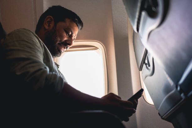 istock tourist taking photo from airplane window 1466014481