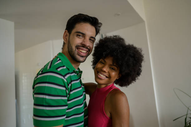 istock happy couple embracing and smiling 1466015243