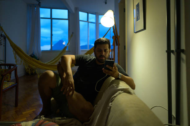 istock tourist using cell phone at home at night 1466015265