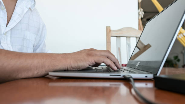 istock tourist using laptop at home 1466015332