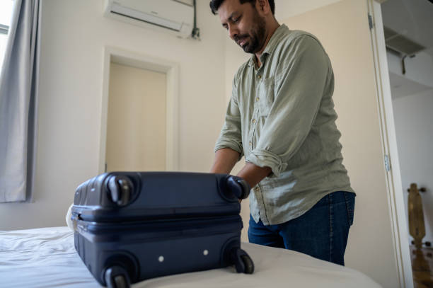 istock tourist opening the suitcase 1466015711