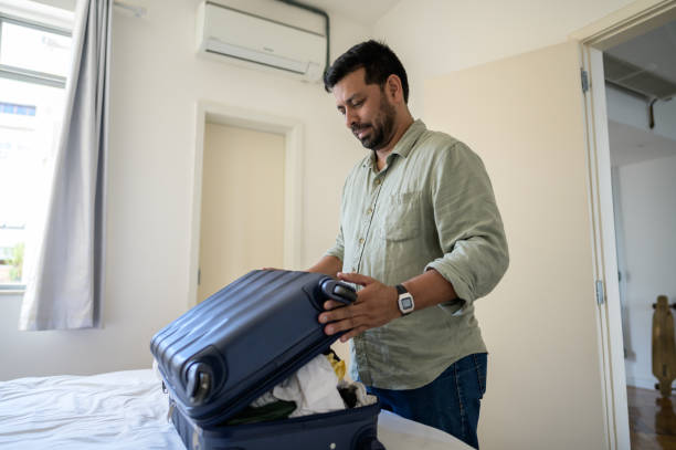 istock tourist opening the suitcase 1466015727