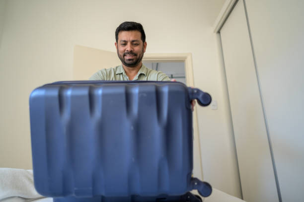 istock tourist opening the suitcase 1466015737