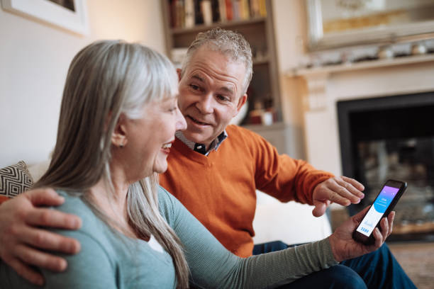 istock Married mature couple using mobile banking app at home and paying online 1466016729