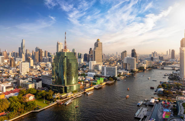 Beautiful panoramic sunset view of the skyline of Bangkok Beautiful panoramic sunset view of the skyline of Bangkok, Bang Rak and Sathon district, Thailand, along the Chao Phraya river thailand temple nobody photography stock pictures, royalty-free photos & images