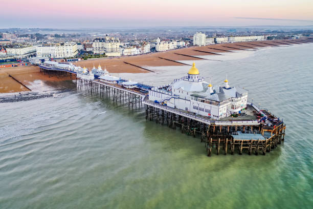 Eastbourne pier East Sussex England Early morning sunlight aerial view of famous Eastbourne pier Enghish Channel East Sussex England Europe eastbourne pier photos stock pictures, royalty-free photos & images