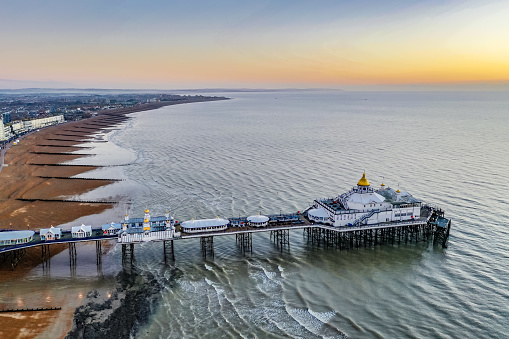 Early morning sunlight aerial view of famous Eastbourne pier Enghish Channel East Sussex England Europe