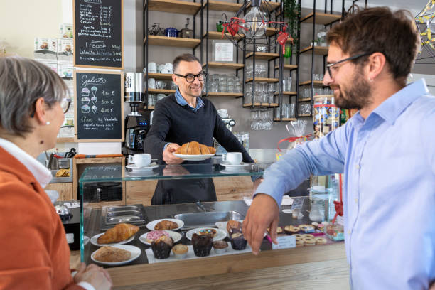 Barman with customers at the bar