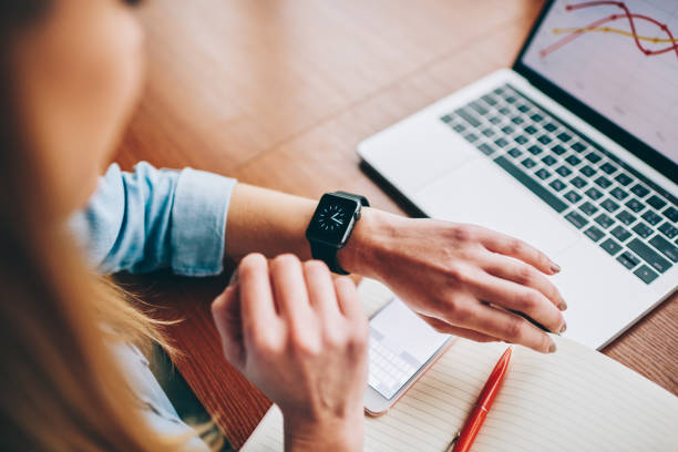 istock Woman watching time on smart watch 1466037260