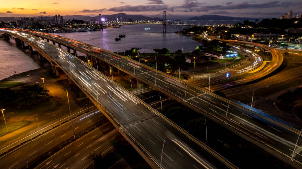 Viaduct with passing car headlights Viaduct with passing car headlights. City of Florianópolis, state of Santa Catarina, southern Brazil. urbane stock pictures, royalty-free photos & images