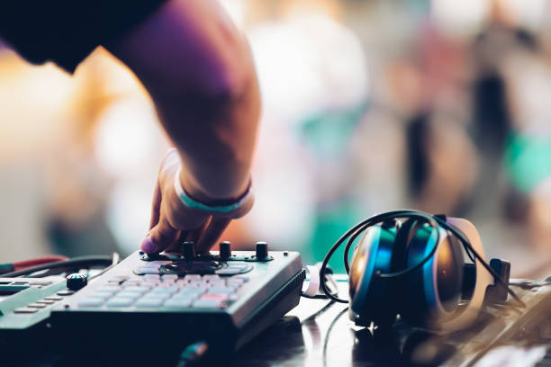istock DJ plays music on summer festival. Disc jockey using midi controller device on concert 1466046818