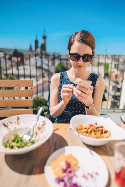 istock Woman eating at rooftop restaurant 1466050544