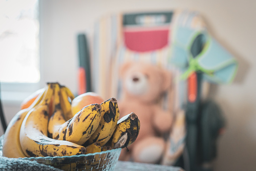 Banana fruits standing on the plate on the kitchen table