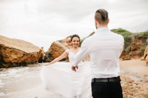istock young couple groom with the bride on a sandy beach 1466051606