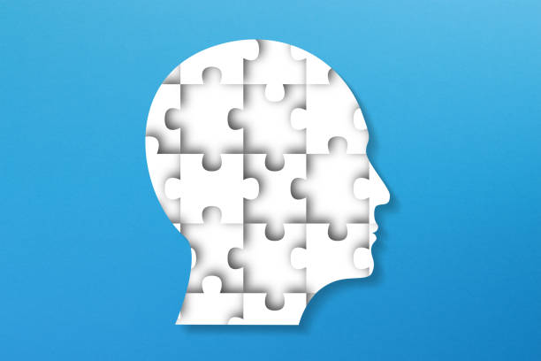 istock Head made of white jigsaw puzzle on blue background 1466055337