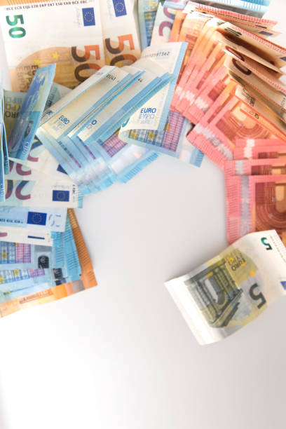 istock Several euro banknotes lying on a white background, with copy space. Conceptual image, crisis, purchasing power, inflation, savings, spending. 1466056378