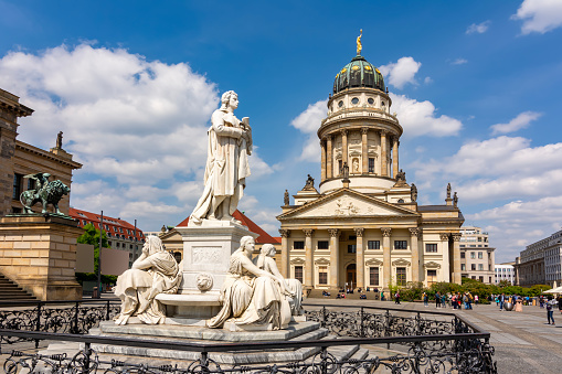 Schiller monument and French church dome on Gendarmenmarkt square, Berlin, Germany