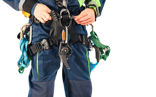 Close up equipment industrial mountaineering worker in uniform on white empty isolated background. Rope access laborer posing in studio. Concept of industry urban works. Copy text space advertising