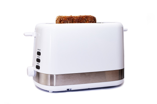 Electric toaster with slices of rye bread, household appliances on a white background.