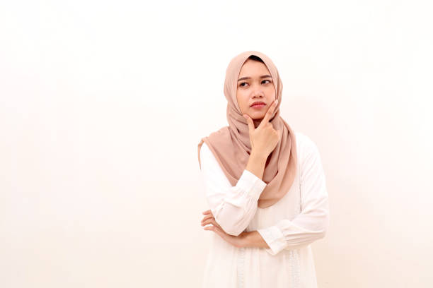 istock Thoughtful young asian muslim woman thinking something seriously while looking sideways. Isolated 1466067730