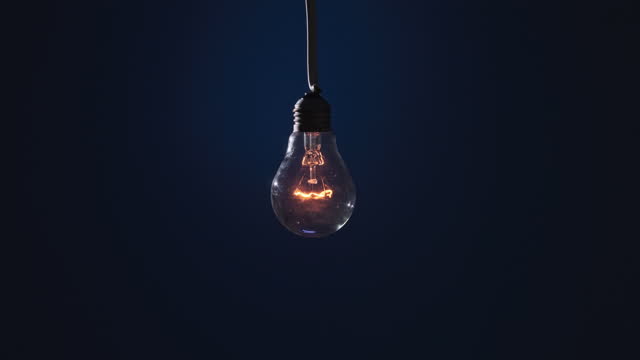 Classic Lamp Glows and Flickers on Dark Blue Background