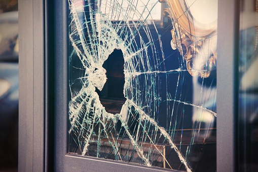 Broken window shop with smashed glass