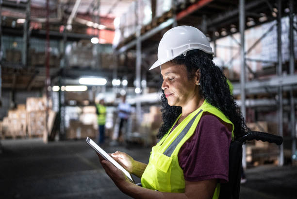 istock Disabled woman working on the digital tablet in a warehouse 1466080489