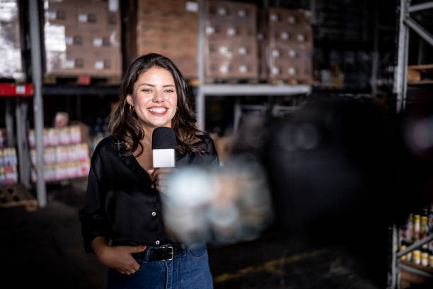 istock Reporter talking on a microphone in a warehouse 1466080618