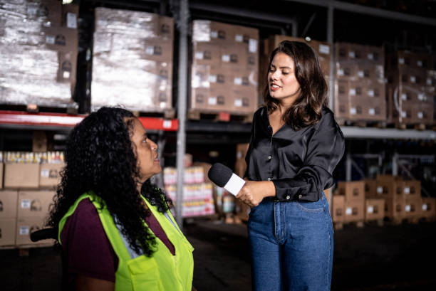 istock Reporter interviewing an employee in a warehouse - including a disabled person 1466081232