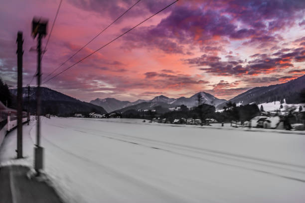 Winter morning with color clouds and big dark hills and train Winter morning with color clouds and big dark nice hills and train spital am pyhrn stock pictures, royalty-free photos & images