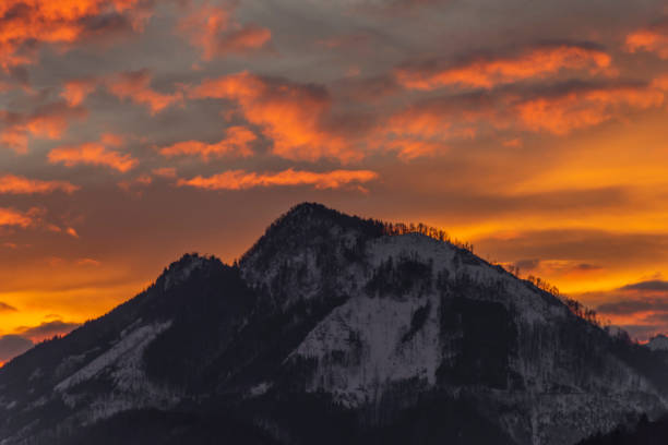 istock Winter morning with color clouds and big dark hills 1466081416