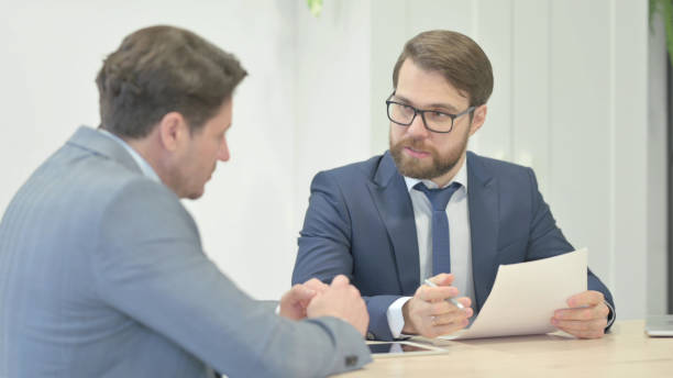 istock Businessman Discussing Project with Partner in Office 1466087532