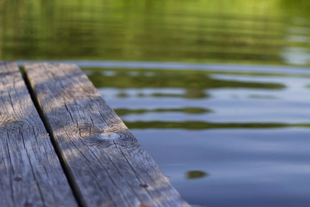wooden pier on the lake in warm summer evening