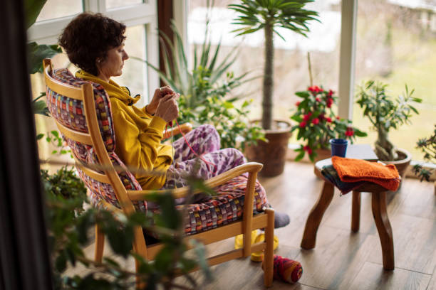 istock Woman knitting at home 1466098389
