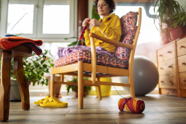 istock Woman knitting at home 1466098431